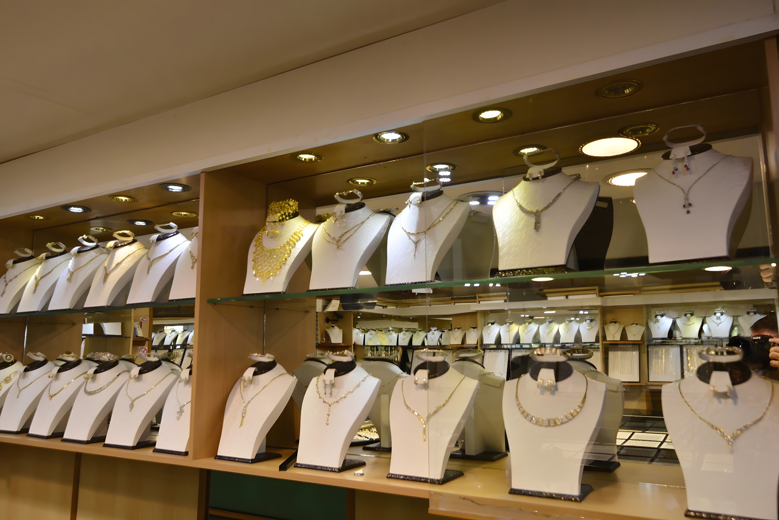 Gold bridal and necklace sets displayed on busts inside Onur Jewellers, Dalston